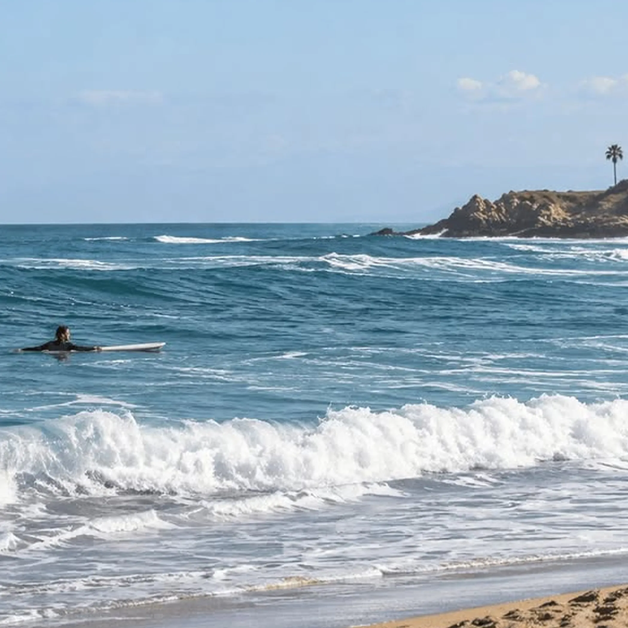 lifeguard and surfer in breaking waves