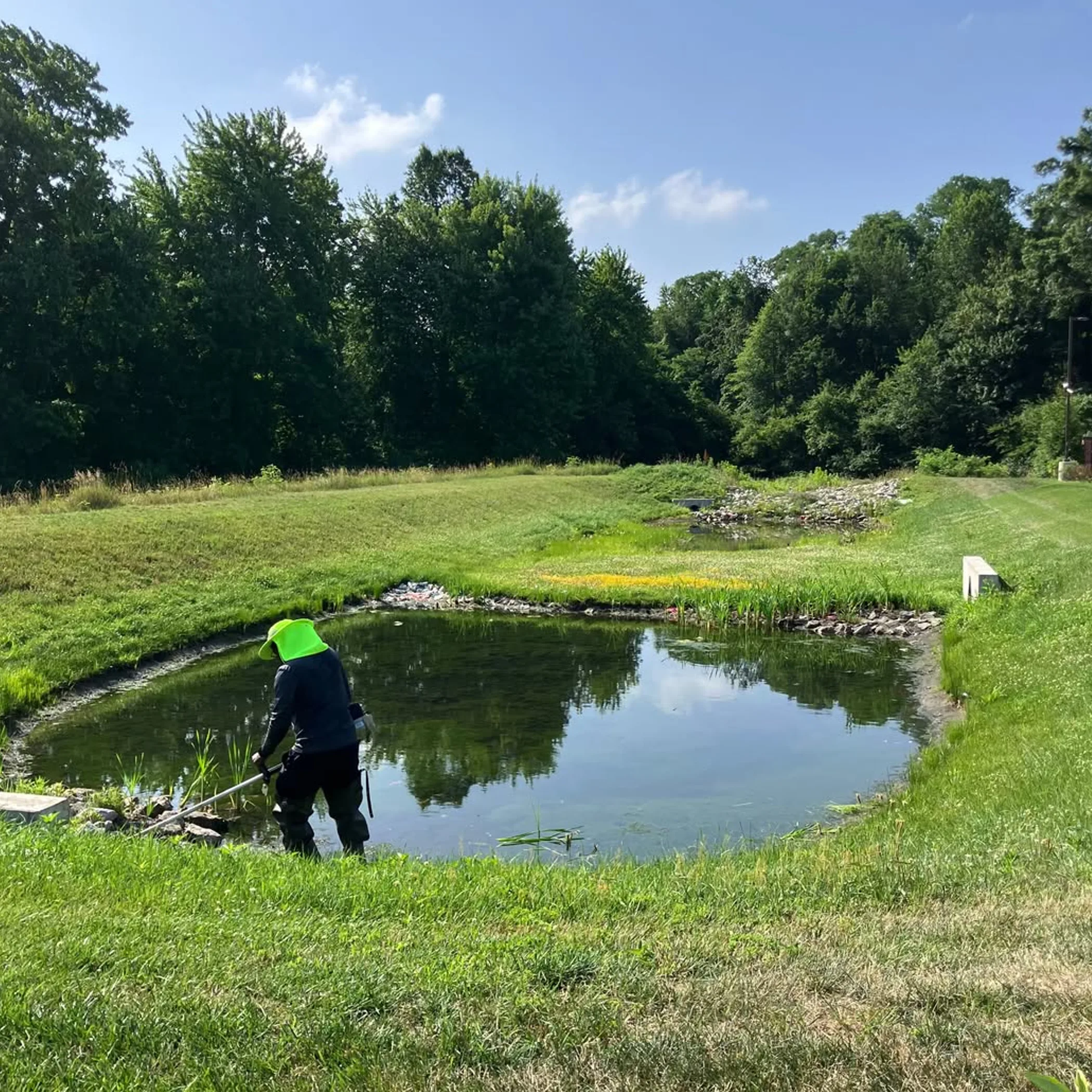 worker maintaining stormwater basin