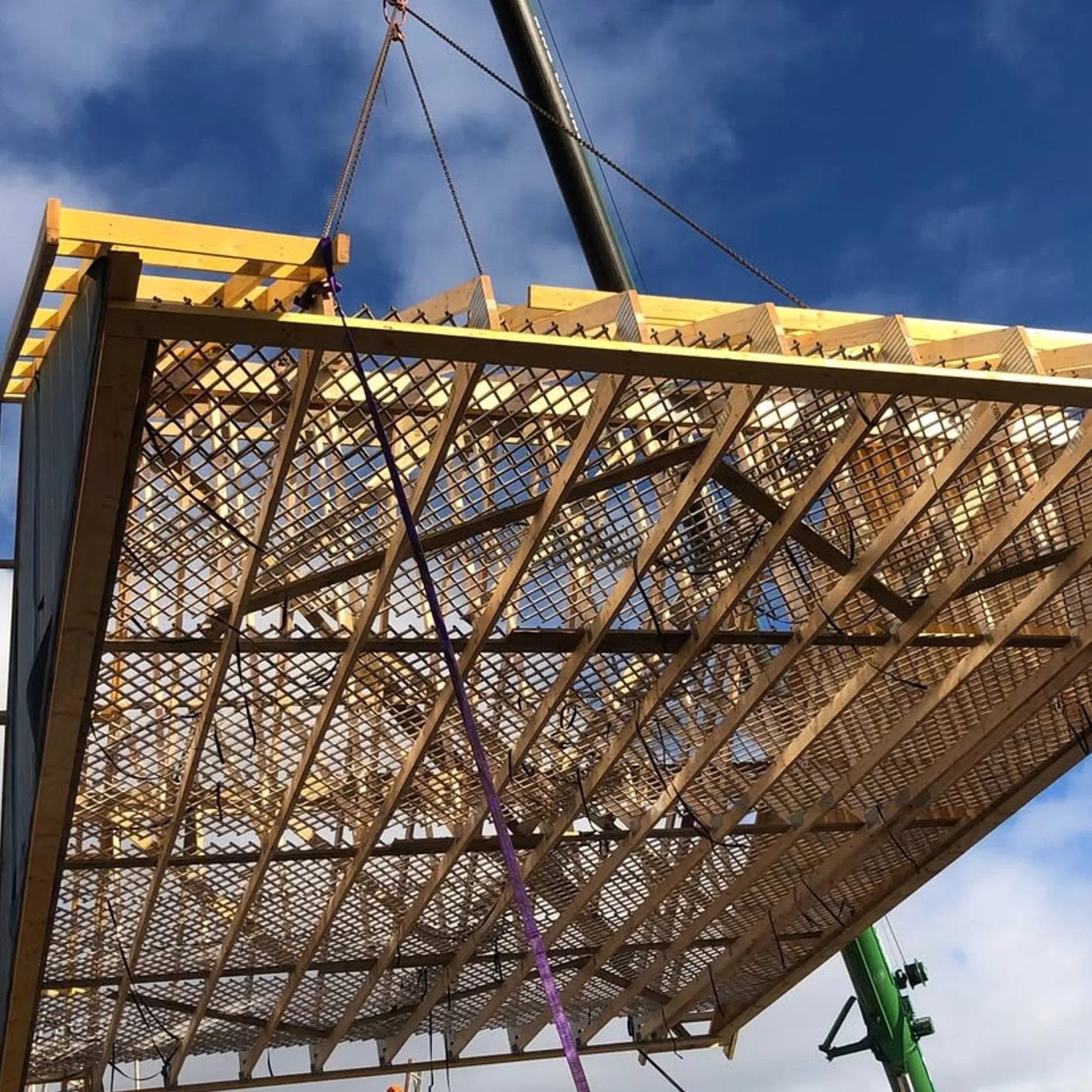 workers installing elevated roof trusses
